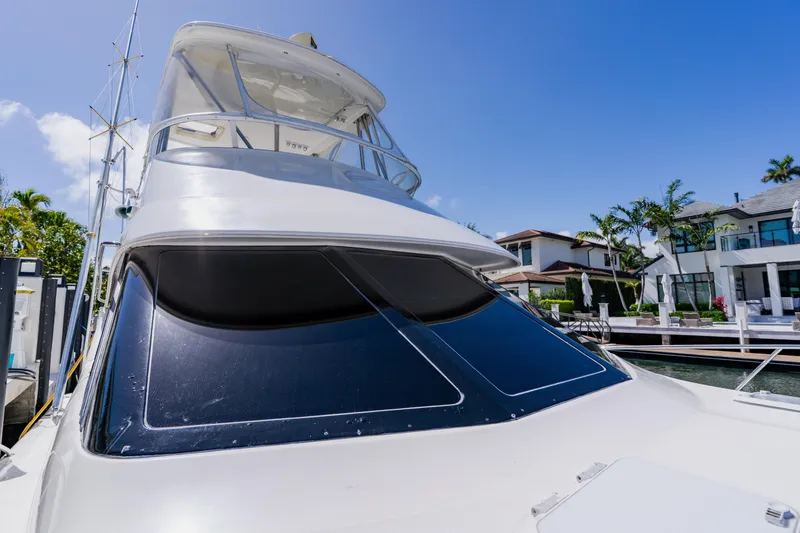 Slide: The Image of 2003 Wellcraft 400 Coastal yacht docked near luxury waterfront homes. - 84