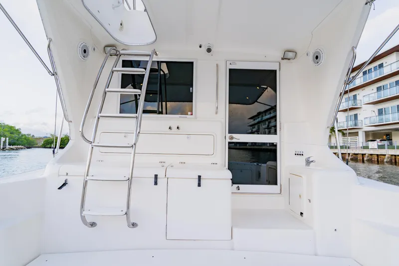 Slide: The Image of 2003 Wellcraft 400 Coastal yacht interior with ladder and door, dockside view. - 87