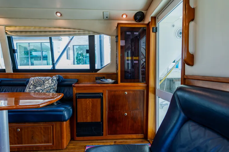 Slide: The Image of Interior of 2003 Wellcraft 400 Coastal yacht with wood cabinetry and seating area. - 88