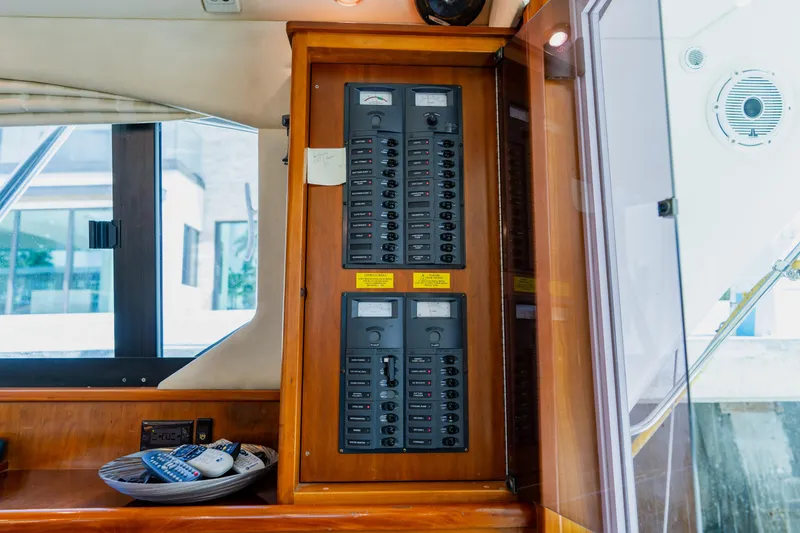 Slide: The Image of Electrical panel inside a 2003 Wellcraft 400 Coastal boat, featuring switches and meters. - 89