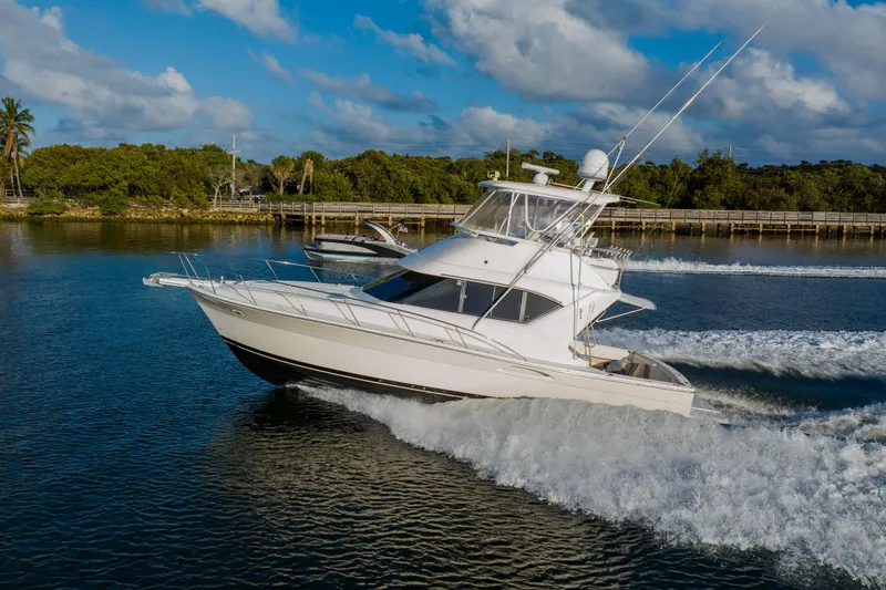 Slide: The Image of 2003 Wellcraft 400 Coastal yacht cruising on a scenic waterway under a blue sky. - 9
