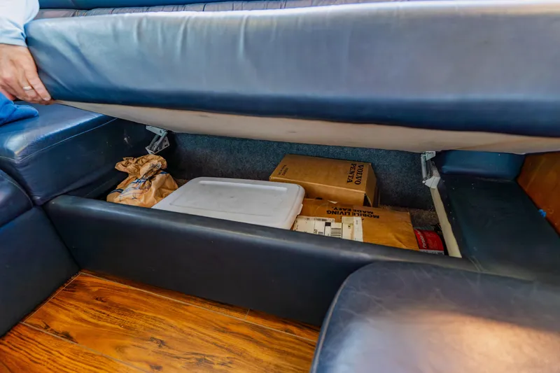 Slide: The Image of Under-seat storage in 2003 Wellcraft 400 Coastal boat, containing boxes and a container. - 96
