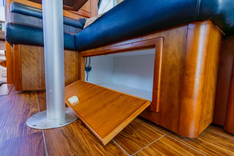 Slide: The Image of Open storage compartment in 2003 Wellcraft 400 Coastal boat interior with wood finish. - 97