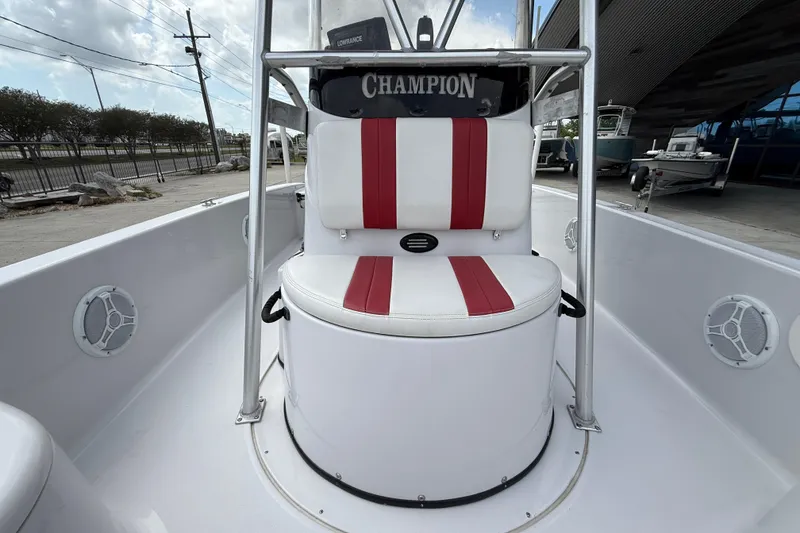 Slide: The Image of 2005 Champion 22 Bay Champ boat interior with red and white seating. - 11