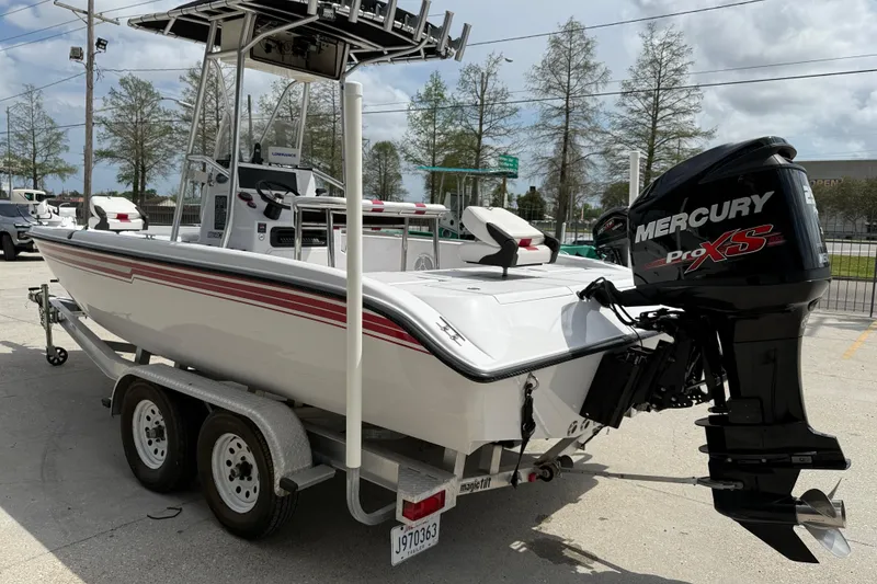 Slide: The Image of 2005 Champion 22 Bay Champ boat with Mercury Pro XS engine on trailer. - 4