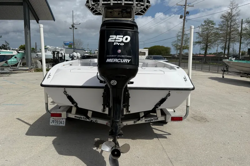 Slide: The Image of 2005 Champion 22 Bay Champ boat with Mercury 250 Pro engine on trailer. - 5