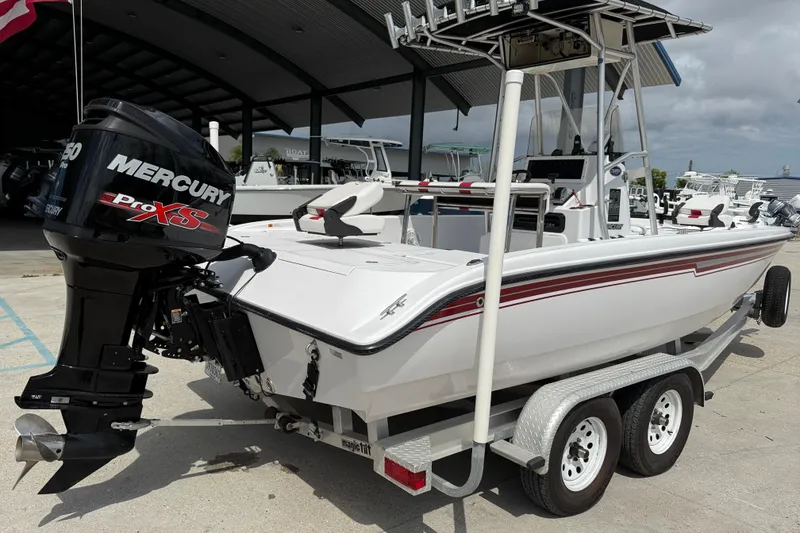 Slide: The Image of 2005 Champion 22 Bay Champ boat with Mercury Pro XS engine on trailer. - 6