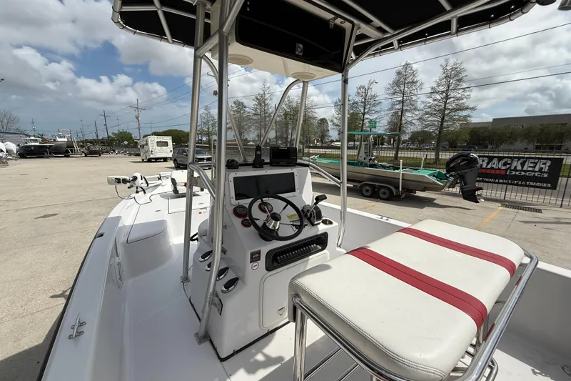 Slide: The Image of 2005 Champion 22 Bay Champ boat interior with steering console and seating. - 8