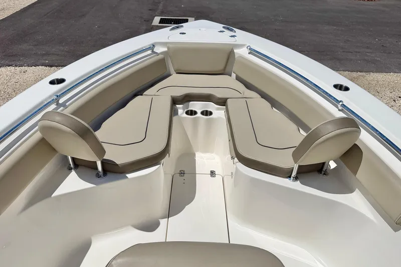 Slide: The Image of 2024 Key West 239 FS boat interior with beige seating and cup holders. - 10