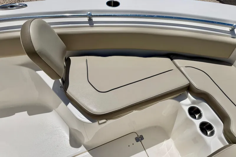 Slide: The Image of 2024 Key West 239 FS boat interior with beige seating and cup holders. - 11