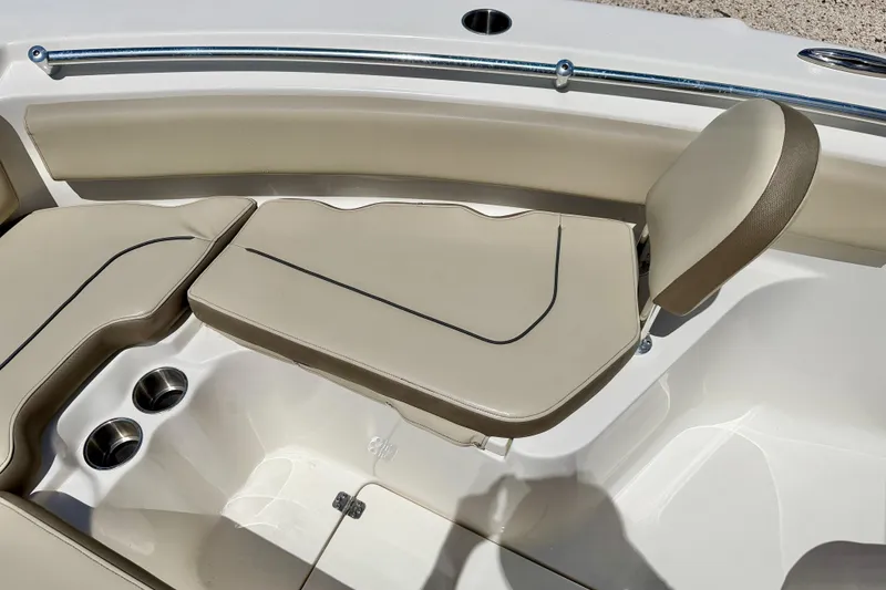 Slide: The Image of 2024 Key West 239 FS boat interior with beige seating and cup holders. - 12