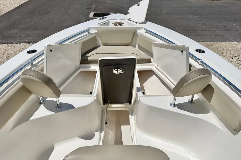 Slide: The Image of 2024 Key West 239 FS boat interior with open storage compartments and seating. - 13