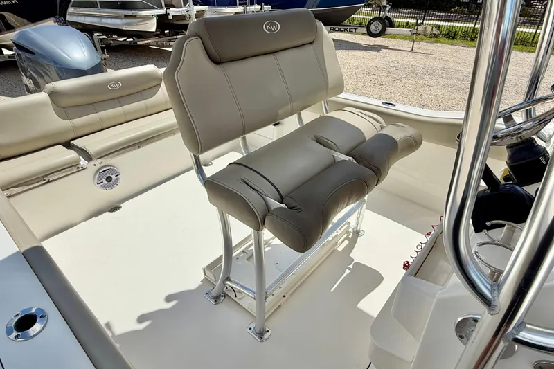 Slide: The Image of 2024 Key West 239 FS boat interior with cushioned seating and steering console. - 16