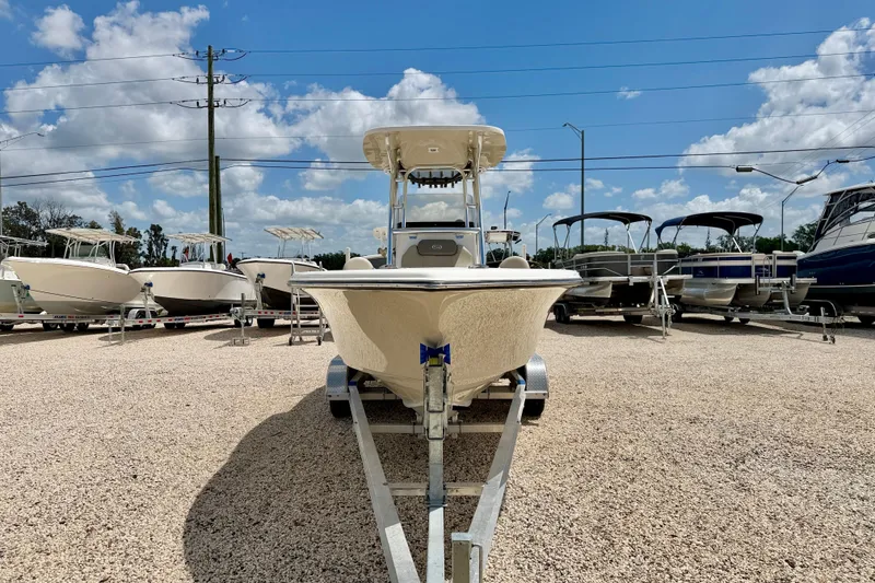 Slide: The Image of 2024 Key West 239 FS boat on trailer under blue sky. - 2