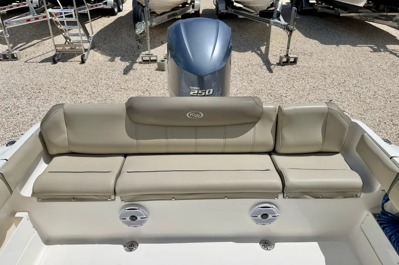 Slide: The Image of 2024 Key West 239 FS boat with cushioned seating and Yamaha 250 engine. - 23