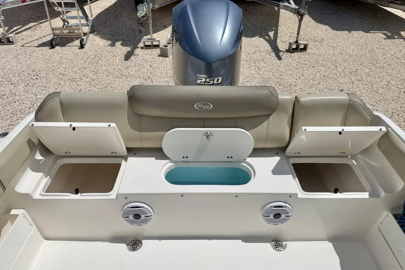Slide: The Image of 2024 Key West 239 FS boat interior with storage compartments and Yamaha 250 engine. - 25