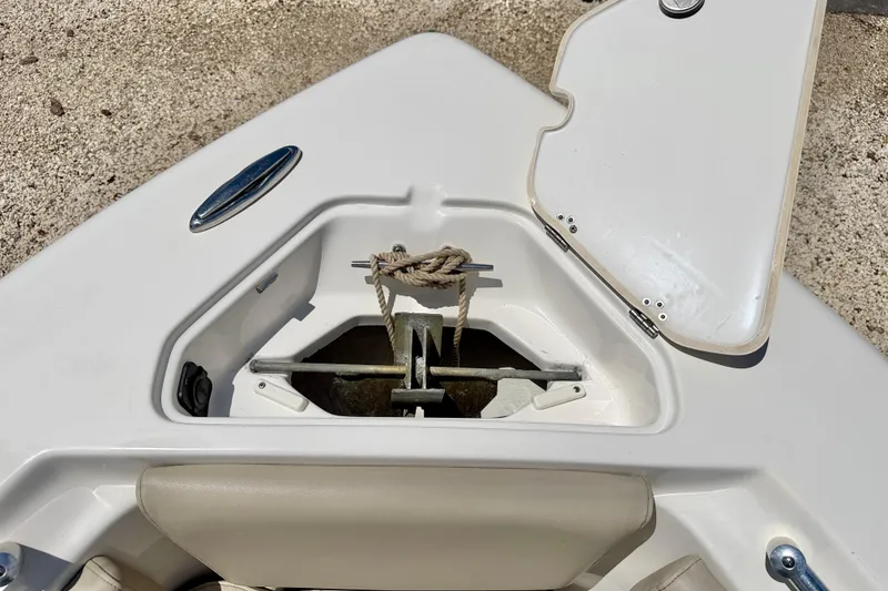 Slide: The Image of Anchor compartment of 2024 Key West 239 FS boat, open hatch, rope visible. - 29