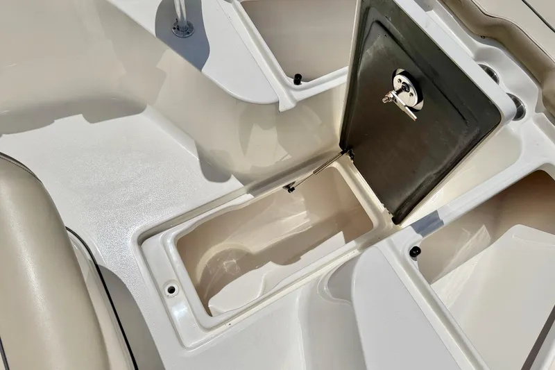 Slide: The Image of 2024 Key West 239 FS boat storage compartment with open hatch and secure lock. - 31