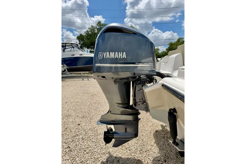 Slide: The Image of 2024 Key West 239 FS boat with Yamaha outboard motor under a cloudy sky. - 32