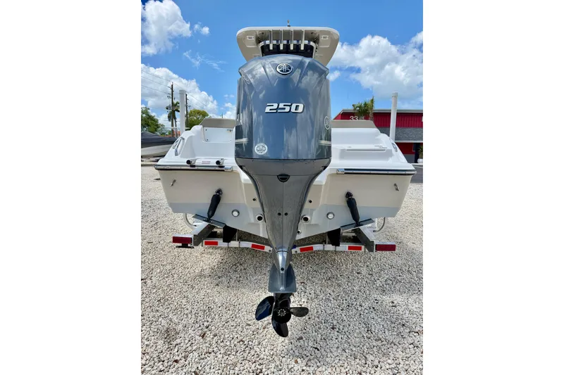 Slide: The Image of 2024 Key West 239 FS boat with Yamaha 250 outboard motor, parked on gravel. - 33