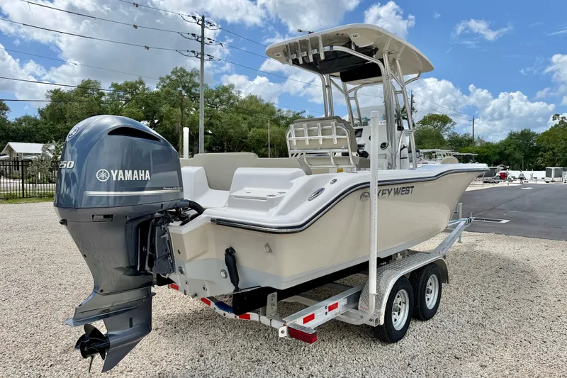 Slide: The Image of 2024 Key West 239 FS boat on trailer with Yamaha engine, parked outdoors. - 5