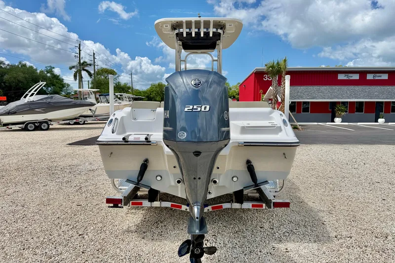 Slide: The Image of 2024 Key West 239 FS boat with Yamaha 250 engine, parked outdoors. - 6