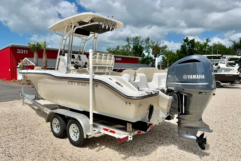 Slide: The Image of 2024 Key West 239 FS boat with Yamaha engine on trailer, parked outdoors. - 7
