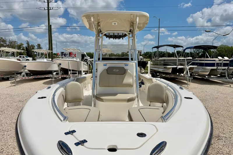 Slide: The Image of 2024 Key West 239 FS boat displayed outdoors under a clear blue sky. - 8