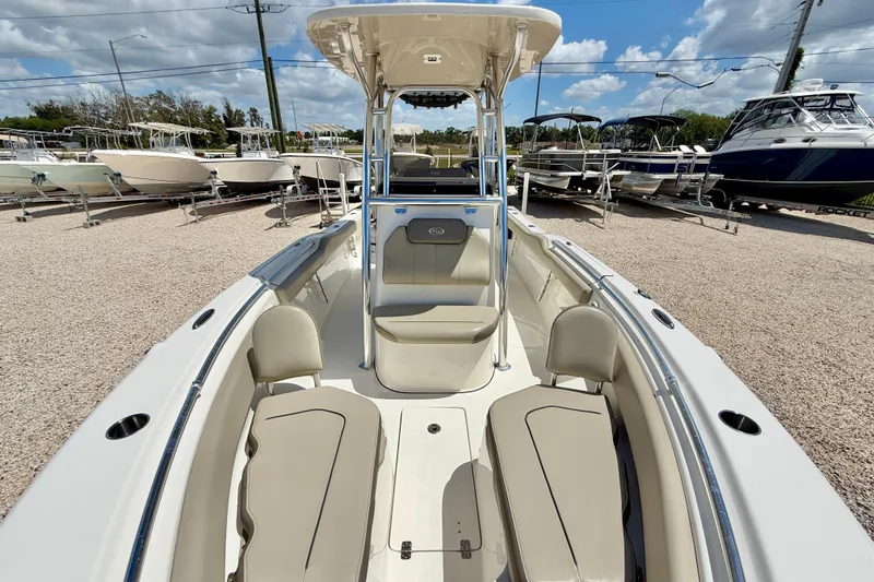 Slide: The Image of 2024 Key West 239 FS boat with spacious seating, displayed outdoors under a blue sky. - 9