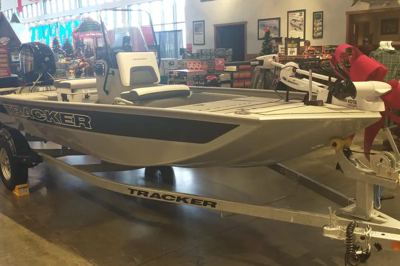 The Image of 2026 Tracker Bass Tracker Classic CC boat displayed indoors with trailer. - 0
