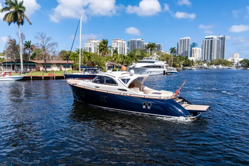 Slide: The Image of 2012 Zeelander 44 yacht cruising on a sunny waterfront with city skyline backdrop. - 6