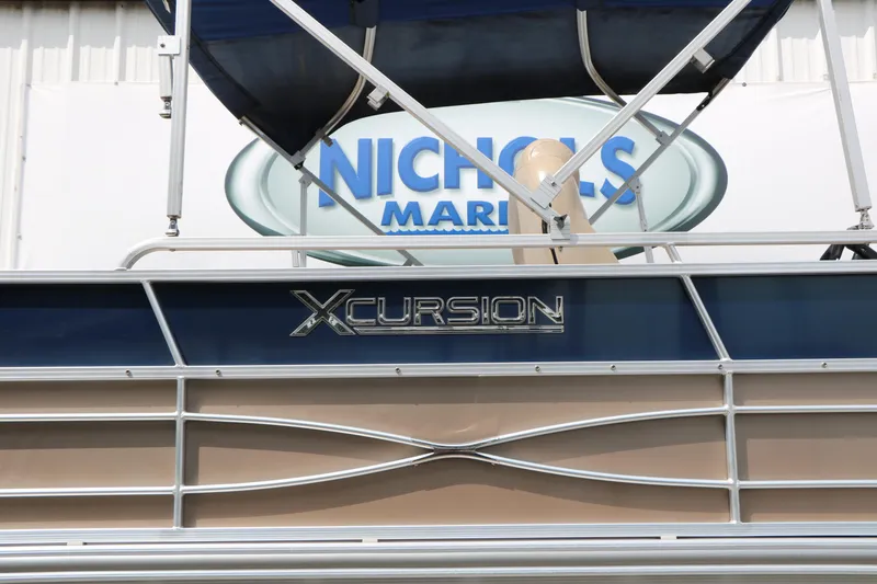 Slide: The Image of 2014 Xcursion X23F boat at Nichols Marine dealership. - 13