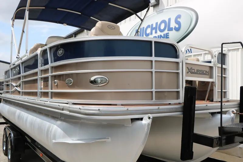 Slide: The Image of 2014 Xcursion X23F pontoon boat with canopy at Nichols Marine dealership. - 14