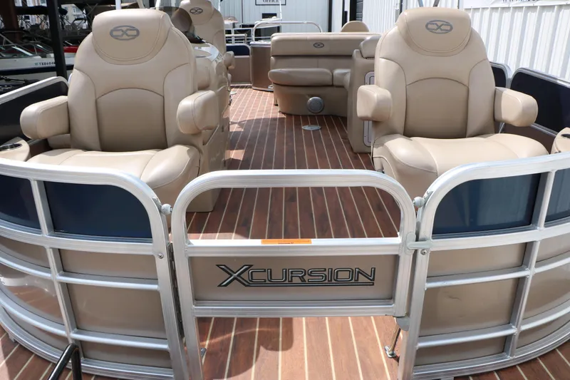 Slide: The Image of 2014 Xcursion X23F pontoon boat with beige seating and wood-style flooring. - 16