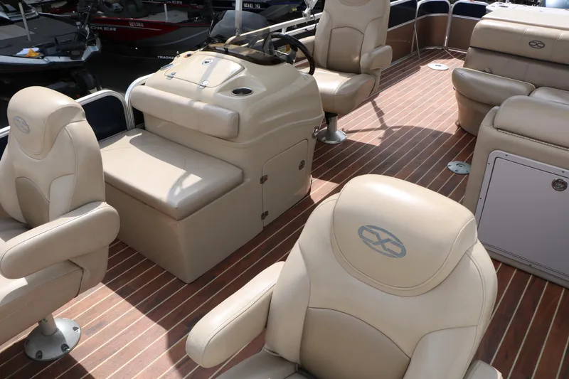 Slide: The Image of Interior of 2014 Xcursion X23F pontoon boat with beige seating and wood flooring. - 19