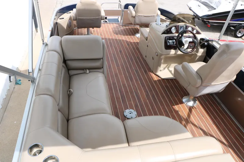 Slide: The Image of Luxurious interior of 2014 Xcursion X23F pontoon boat with plush seating and sleek dashboard. - 22