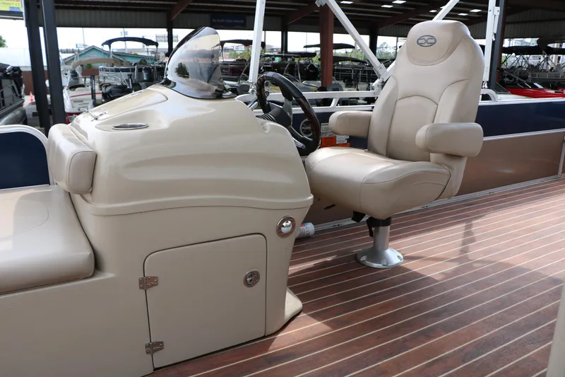 Slide: The Image of 2014 Xcursion X23F boat interior with captain's chair and steering console. - 24