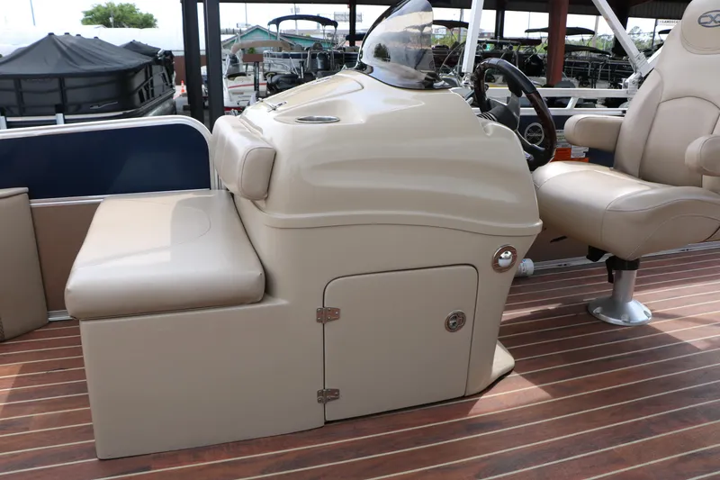 Slide: The Image of 2014 Xcursion X23F boat interior with beige seating and wooden flooring. - 25