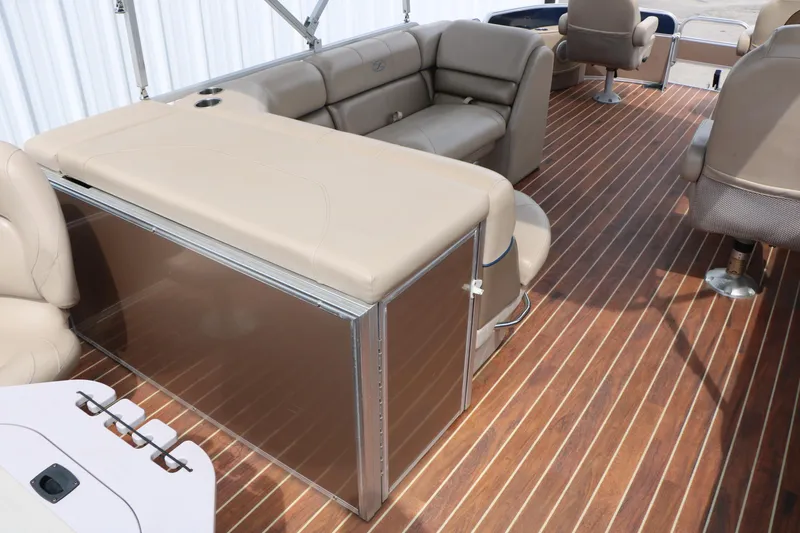Slide: The Image of 2014 Xcursion X23F pontoon boat interior with beige seating and wood-style flooring. - 28