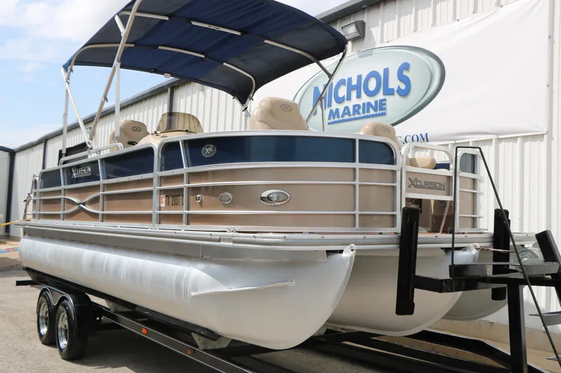 Slide: The Image of 2014 Xcursion X23F pontoon boat with canopy at Nichols Marine dealership. - 3