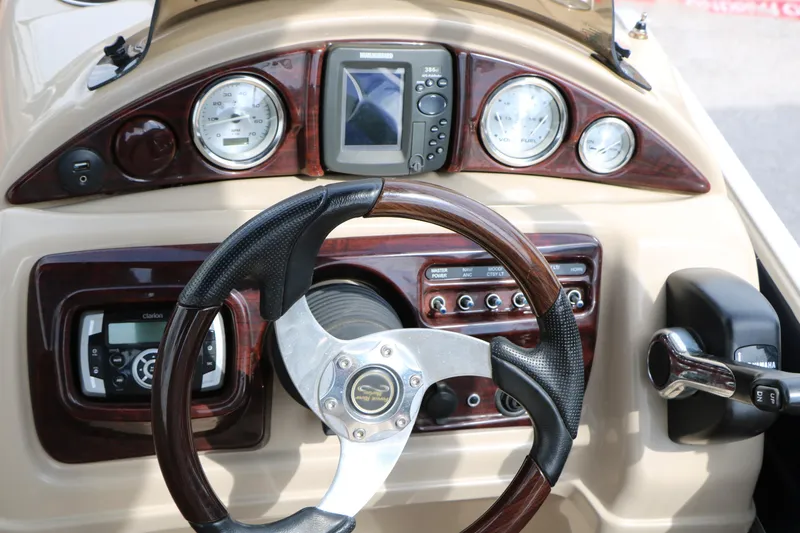 Slide: The Image of 2014 Xcursion X23F boat dashboard with steering wheel and control panel. - 32