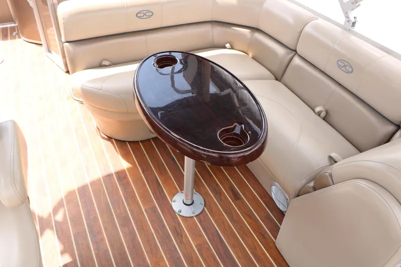 Slide: The Image of Luxurious 2014 Xcursion X23F boat interior with plush seating and elegant wooden table. - 36