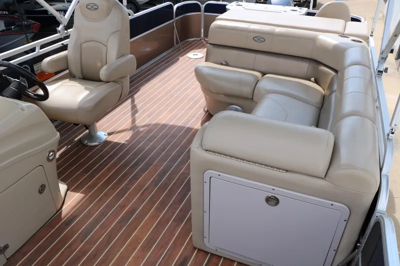 Slide: The Image of 2014 Xcursion X23F pontoon boat interior with beige seating and wood-style flooring. - 39