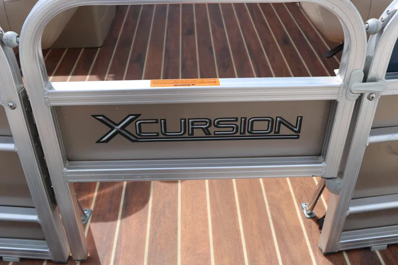 Slide: The Image of 2014 Xcursion X23F boat gate with logo on wooden deck. - 40