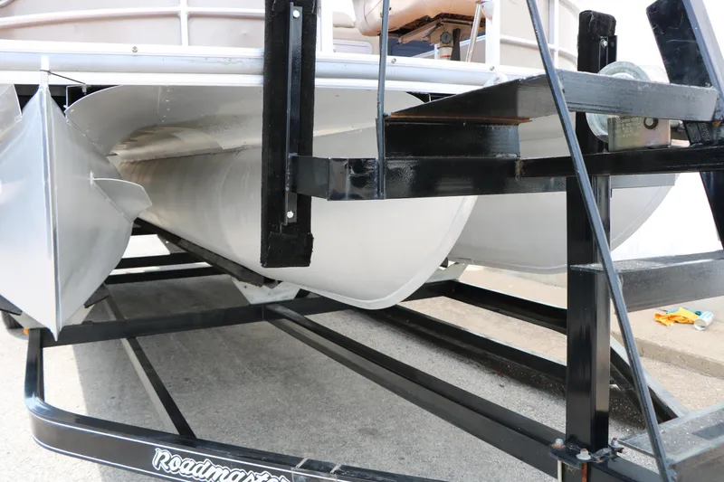 Slide: The Image of Trailer-mounted 2014 Xcursion X23F pontoon boat, showcasing undercarriage and pontoons. - 41