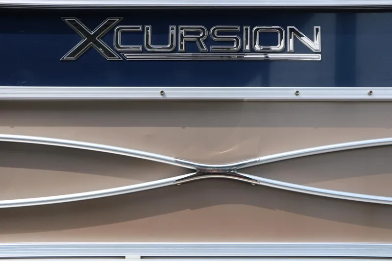 Slide: The Image of 2014 Xcursion X23F boat emblem with sleek metallic design. - 42