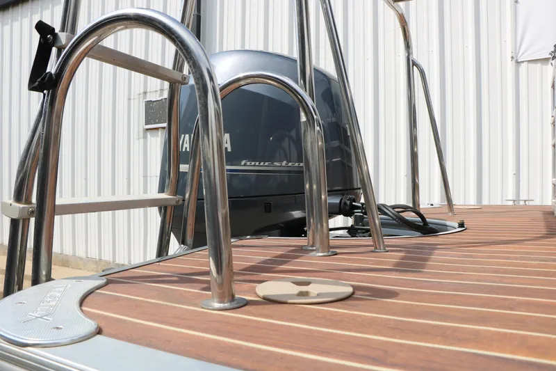 Slide: The Image of 2014 Xcursion X23F boat with Yamaha engine and wooden deck. - 43