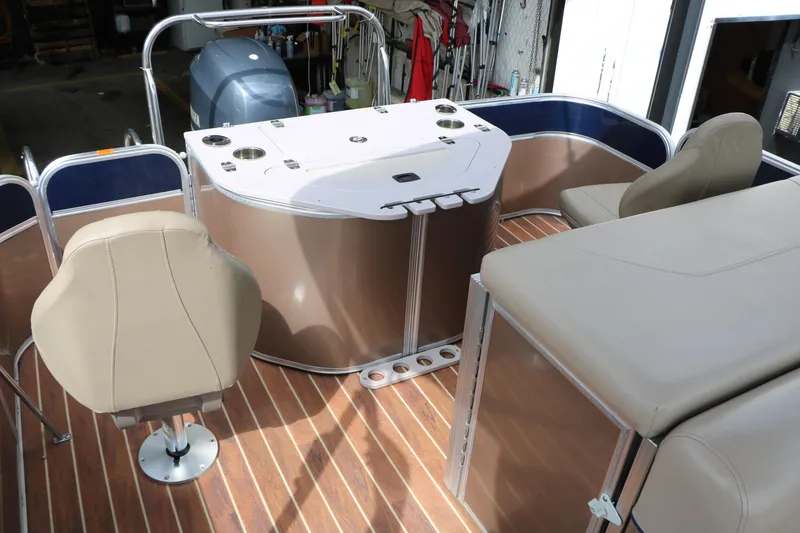 Slide: The Image of 2014 Xcursion X23F pontoon boat interior with seating and helm station. - 45