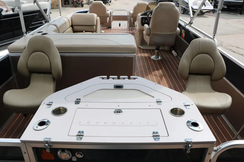 Slide: The Image of 2014 Xcursion X23F pontoon boat interior with beige seating and wood-style flooring. - 46