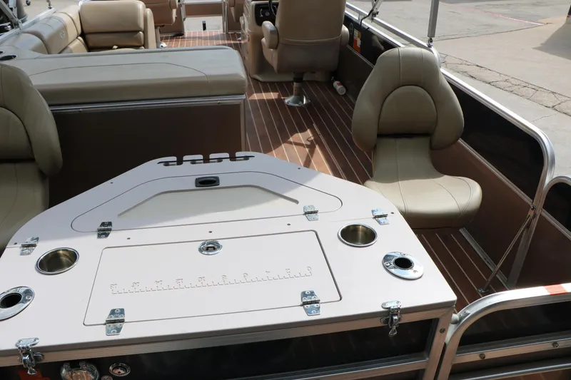 Slide: The Image of 2014 Xcursion X23F pontoon boat interior with beige seating and fishing station. - 48